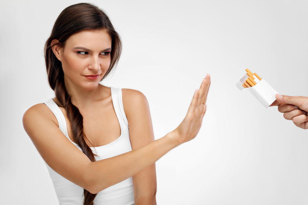 Healthy,Young,Woman,Refusing,To,Take,Cigarette,From,Pack.,Portrait