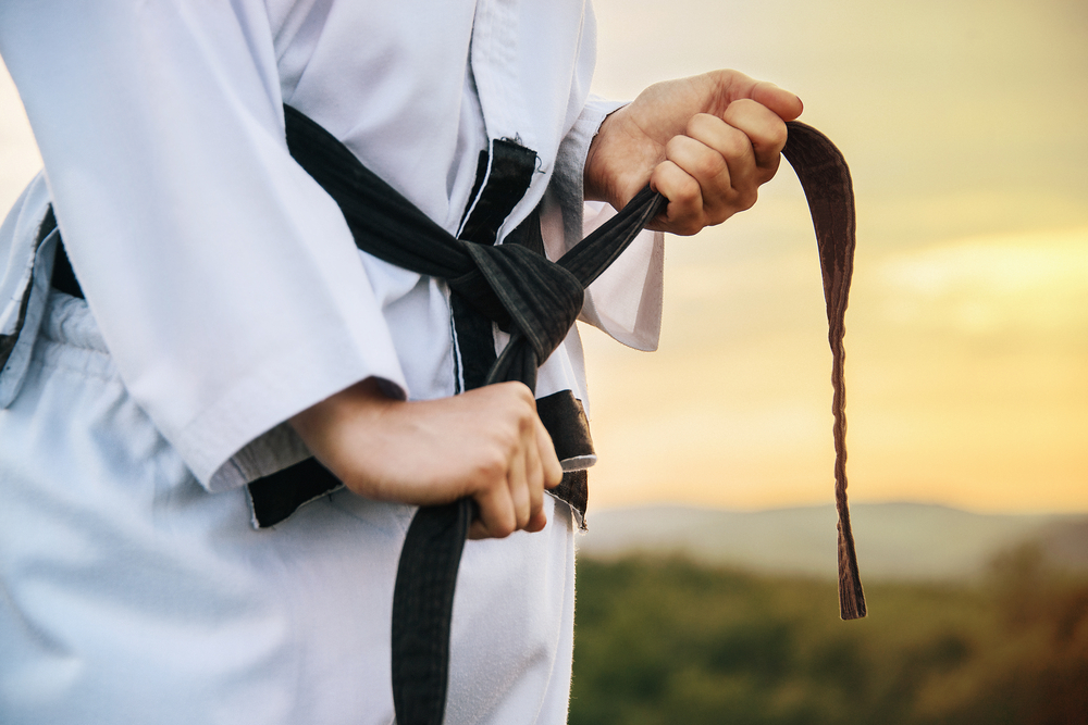 A,Young,Martial,Arts,Master,Knots,A,Black,Belt.,Close-up.