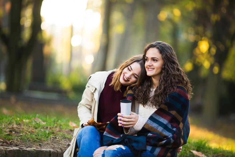 Two,Beautiful,Young,Women,Drinking,Coffee,Outdoors,In,The,Autmn