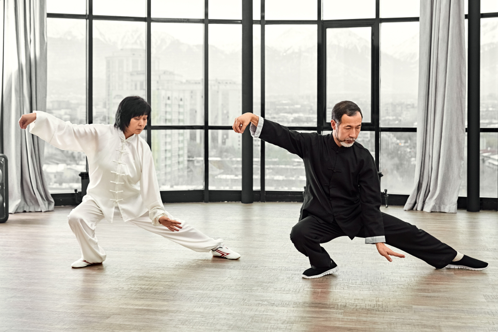 Couple,Of,Senior,Masters,Practicing,Qi,Qong,Taijiquan,At,Studio.