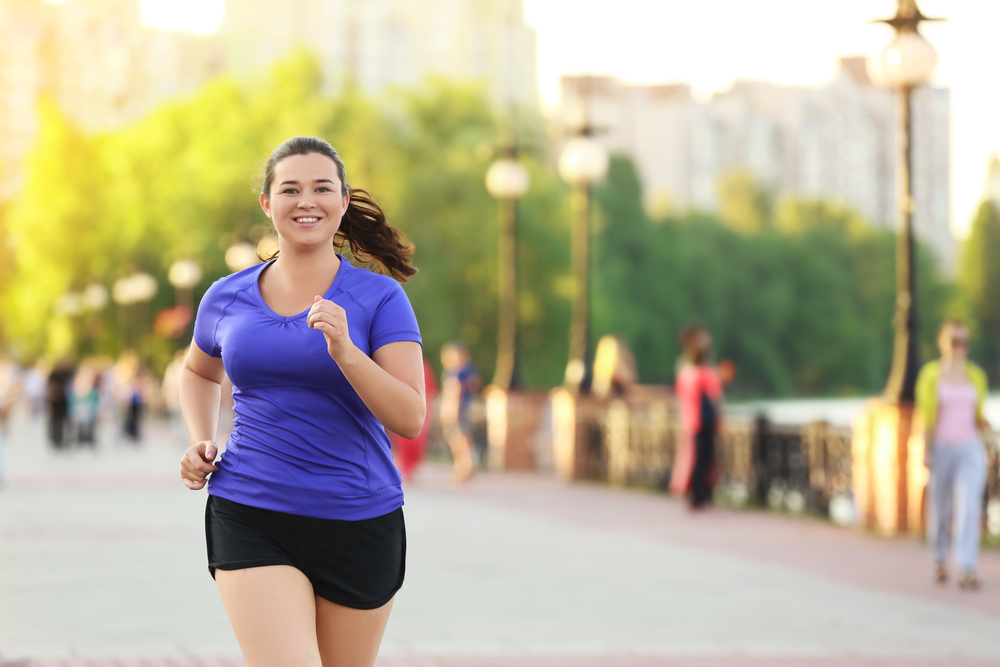 Overweight,Young,Woman,Jogging,In,The,Street.,Weight,Loss,Concept