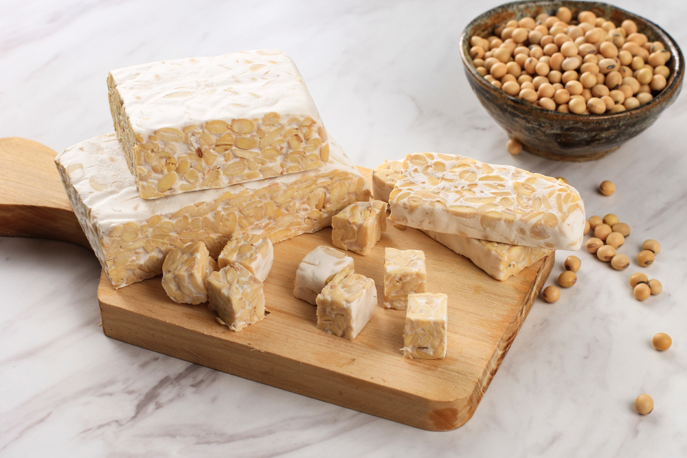 Raw,Tempeh,Or,Tempe.,Tempeh,Slices,On,Wooden,Background,,Cut