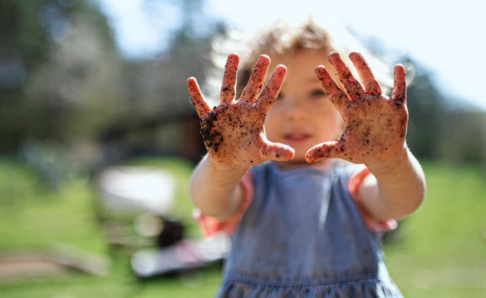 Small,Girl,Showing,Dirty,Hands,Outdoors,In,Garden,,Sustainable,Lifestyle