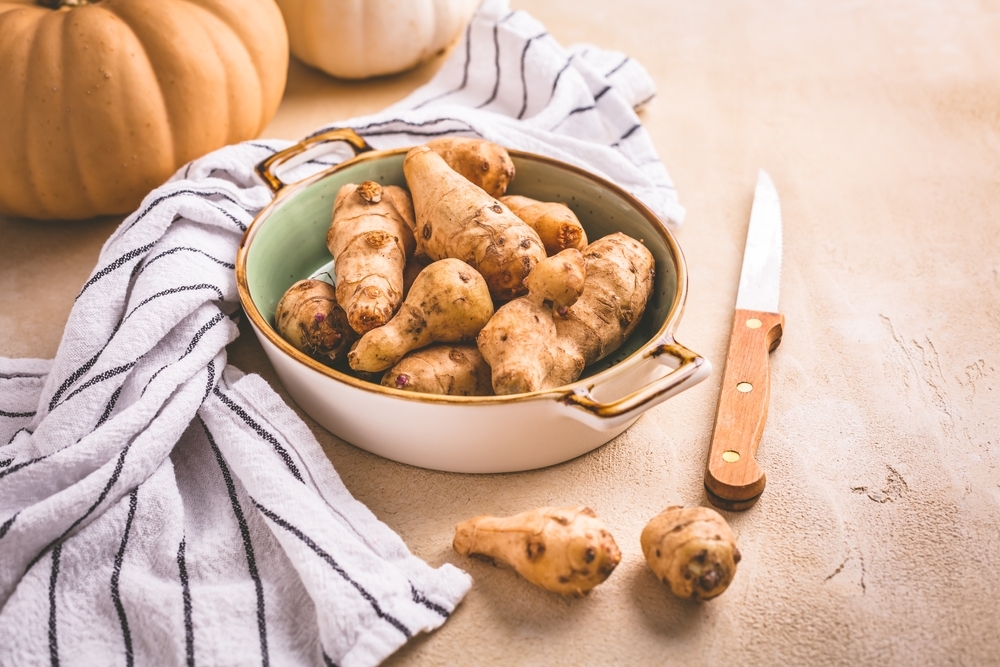 Raw,Topinambour,With,Pumpkins,In,Bowl,On,Kitchen,Table