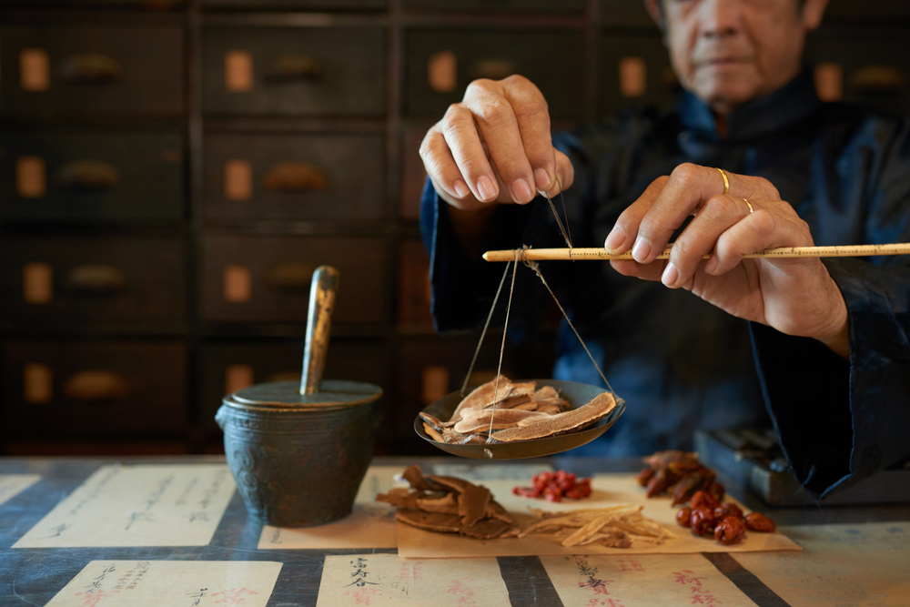 Man,Measuring,Ingredients,In,Traditional,Asian,Apothecary
