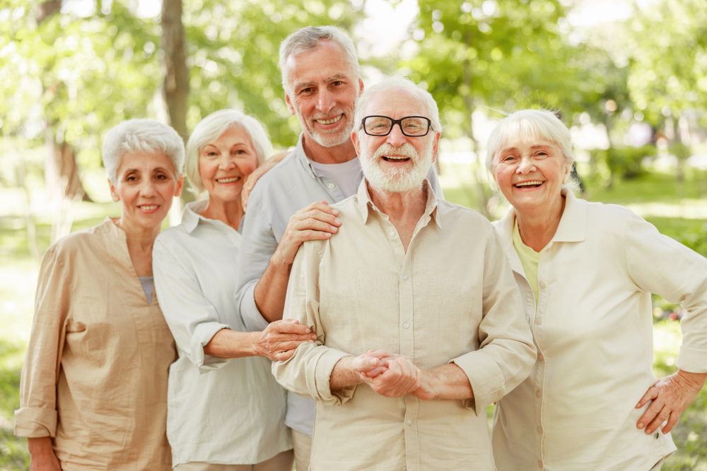 Group,Of,Old,People,Looking,At,Camera,And,Smiling,Stock