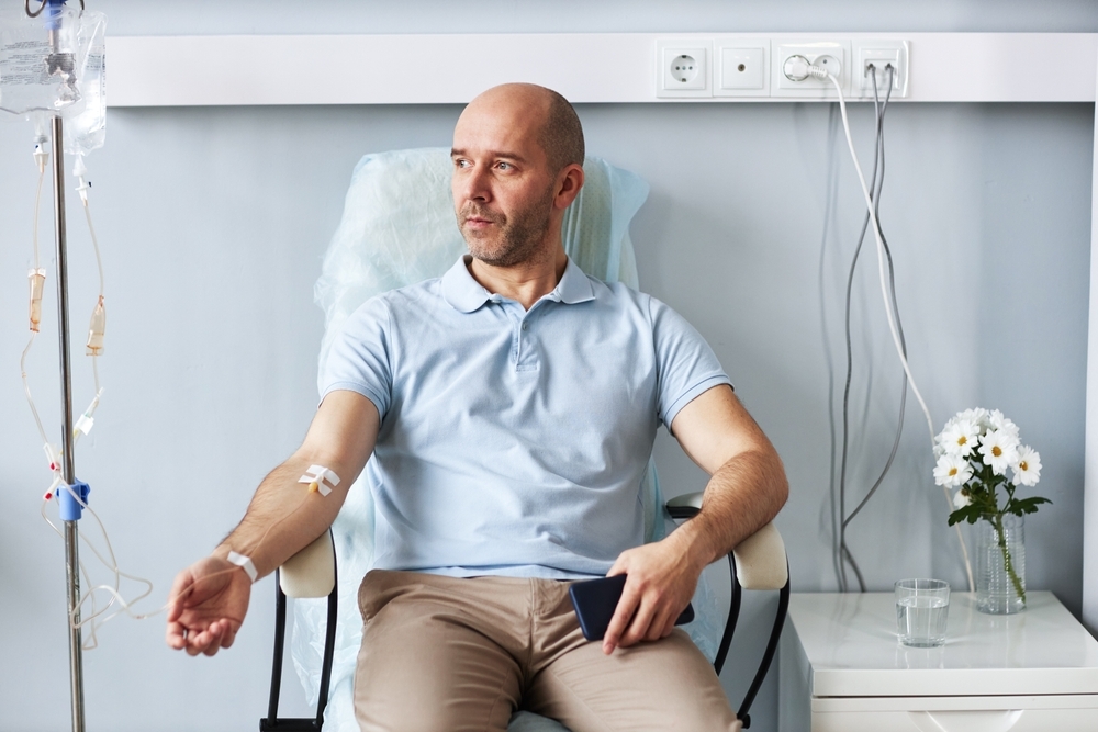 Portrait,Of,Adult,Man,Sitting,In,Comfortable,Chair,With,Iv