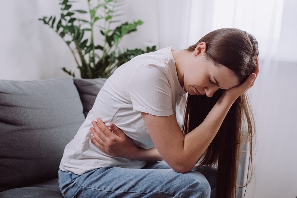 Top,View,Stressed,Unhappy,Young,Woman,Lying,In,Fetal,Position