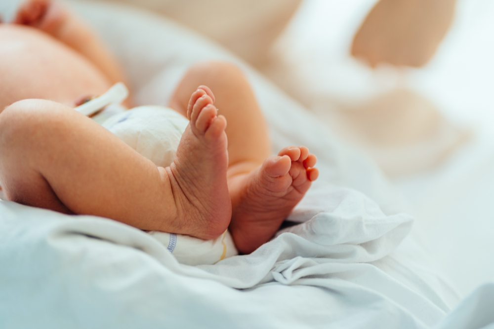 New,Born,Baby,Feet,On,White,Blanket,In,Hospital