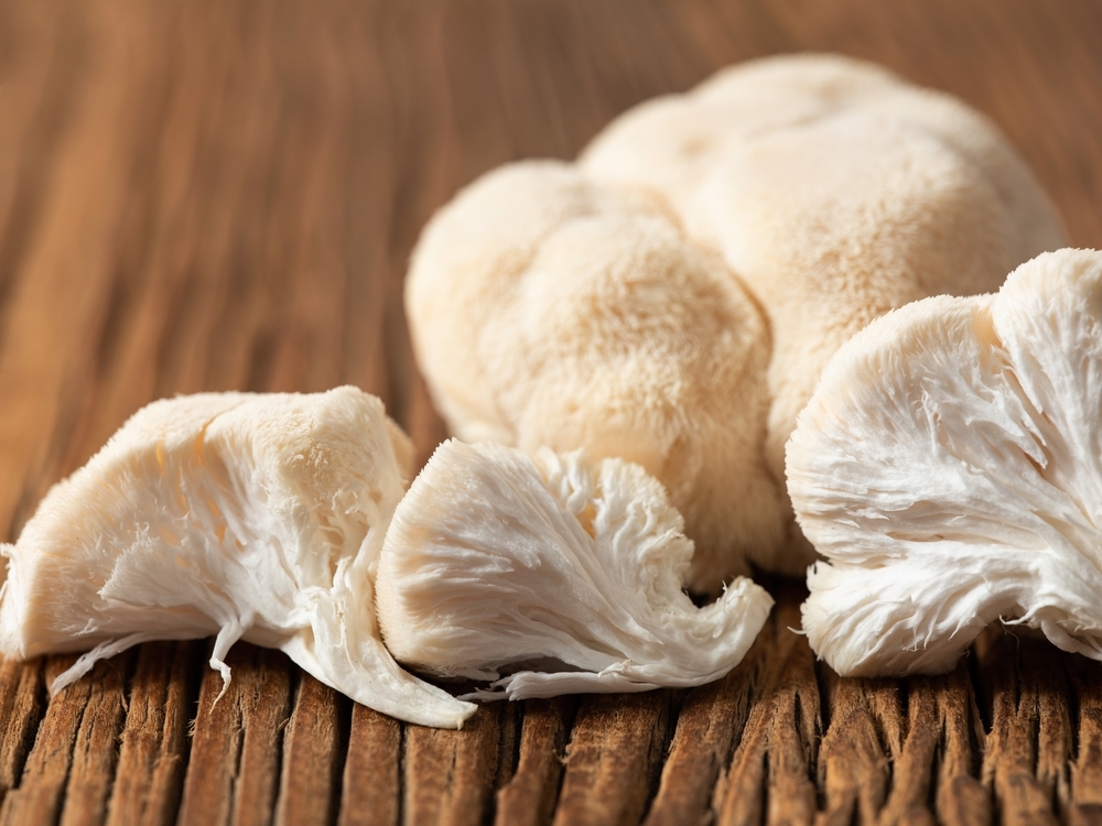 Hericium,Erinaceus,Mushroom,On,Wooden,Background