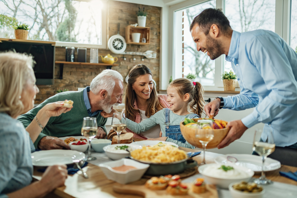 Happy,Multi-generation,Family,Gathering,Around,Dining,Table,And,Having,Fun