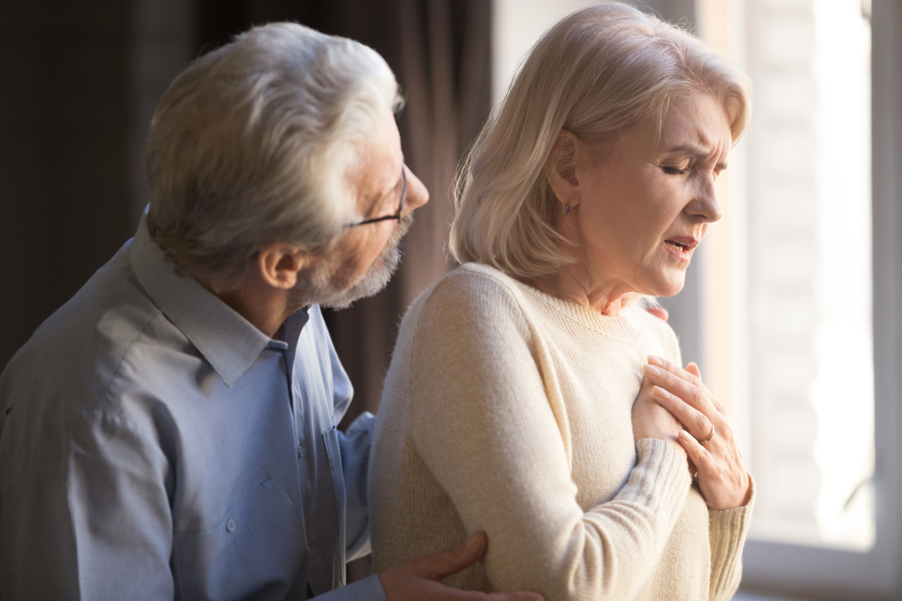 Close,Up,Focus,On,Elderly,Wife,Hold,Hand,On,Breast