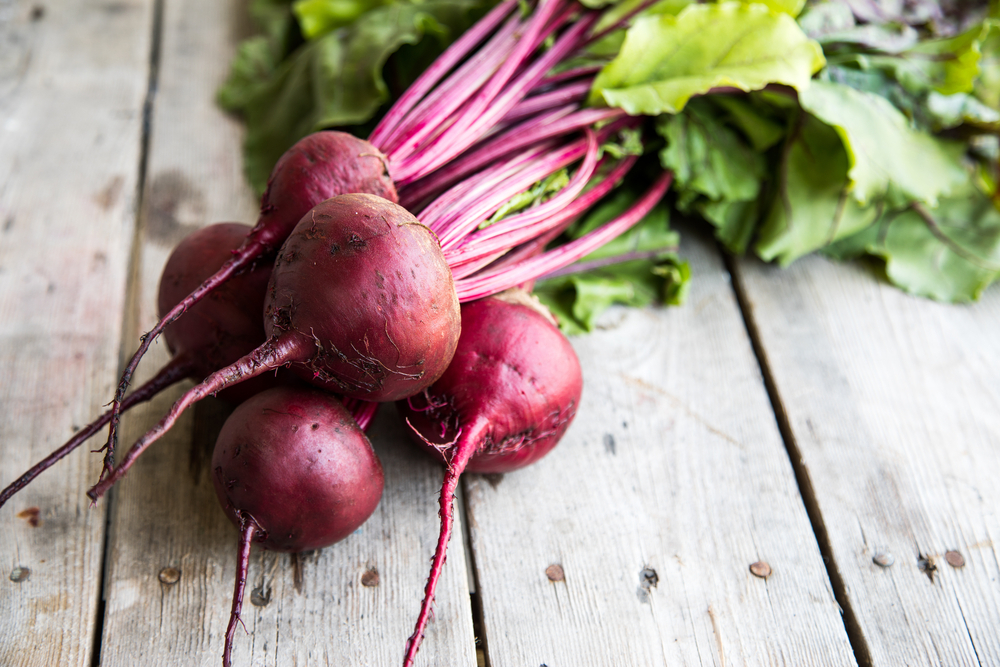 Red,Beetroot,With,Herbage,Green,Leaves,On,Rustic,Background.,Organic