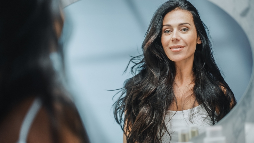 Beautiful,Caucasian,Middle,Aged,Woman,Looks,Into,Bathroom,Mirror,,Enjoys