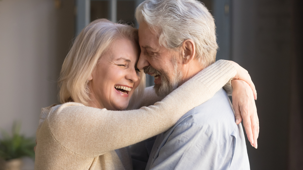 Happy,Mature,Couple,In,Love,Embracing,,Laughing,Grey,Haired,Husband