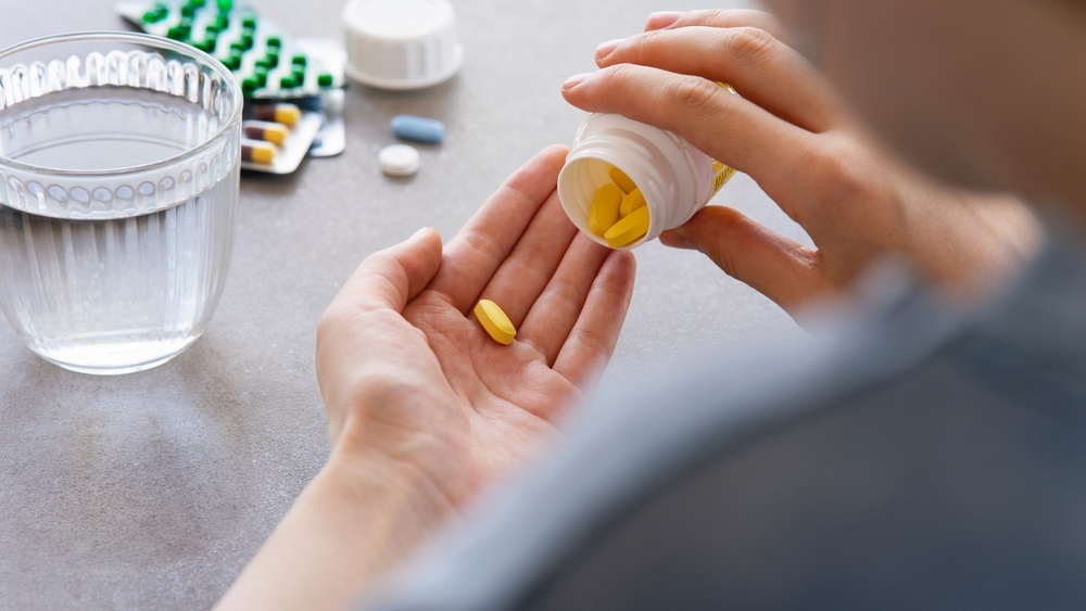 Close,Up,Woman,Holding,Pill,In,Hand,With,Water.,Female