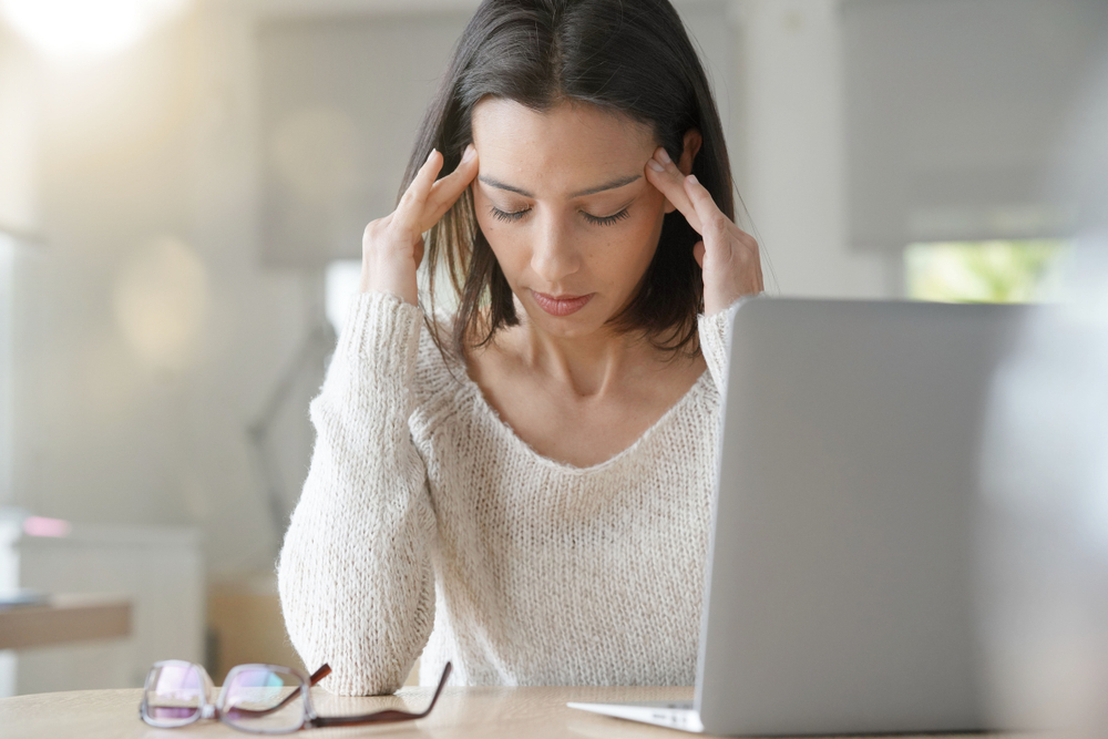 Woman,Working,On,Laptop,Having,A,Headache
