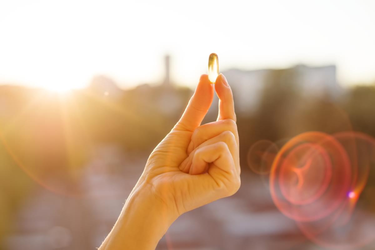 Hand,Of,A,Woman,Holding,Fish,Oil,Omega-3,Capsules,,Urban
