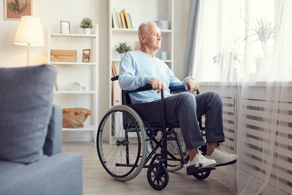 Content,Pensive,Senior,Man,Sitting,In,Wheelchair,And,Looking,Out